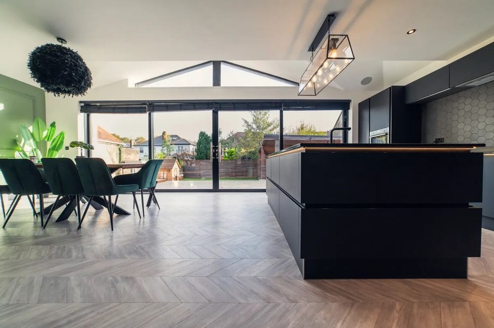 Dark modern open-plan kitchen extension interior